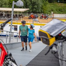 Two cyclists at the boat landing stage