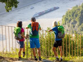 Drei Wanderer am Rheinsteig mit Aussicht auf Rhein