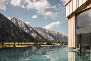 Outdoor pool with panoramic mountain view Hotel Kristall