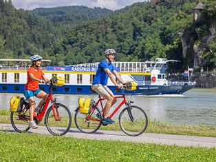 Two cyclists on the blue Danube