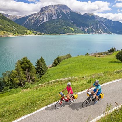 Panoramic view of two cyclists on Lake Resia